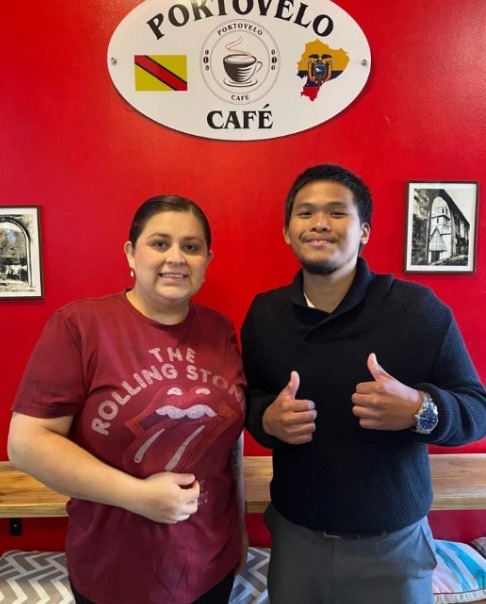 GT Payments rep with the owner of Portovelo Café in front of the café sign